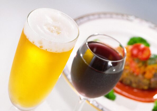 「グラスに注がれたビールと赤ワイン、発酵による芳醇な香りと料理とのペアリングを楽しむ食卓風景｜世界の醸造文化と食の豊かさを表現」